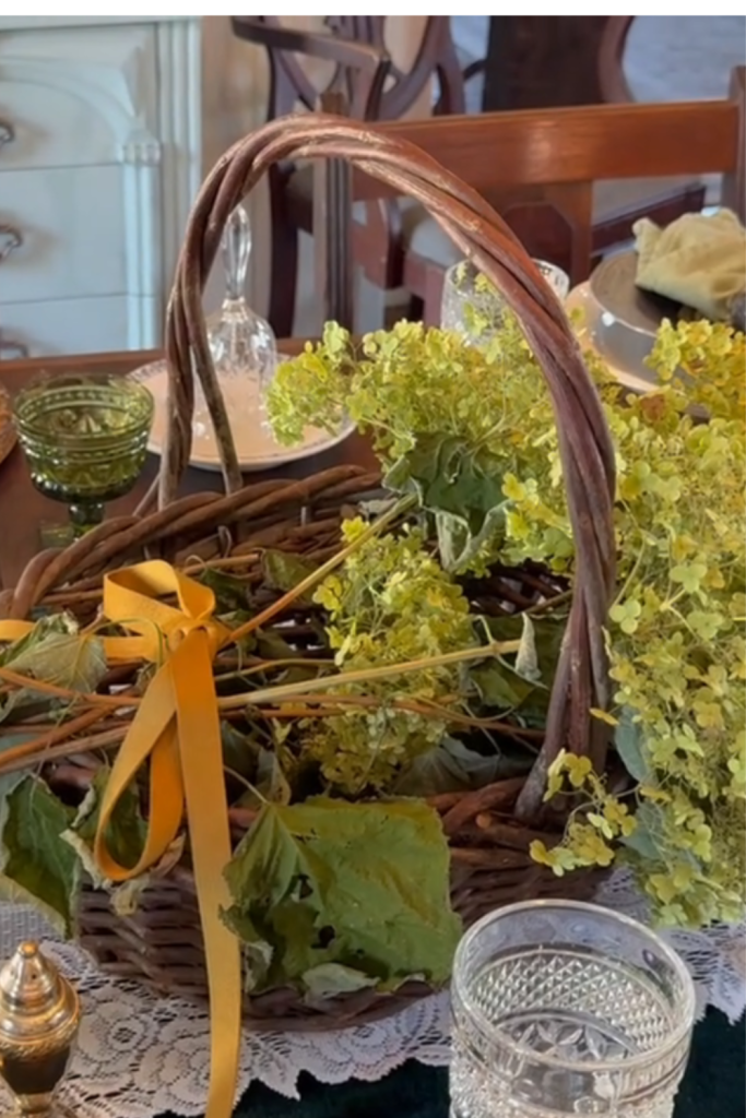 Vintage fall decor featuring fresh Limelight hydrangeas arranged in a rustic basket on our historic home dining room table.