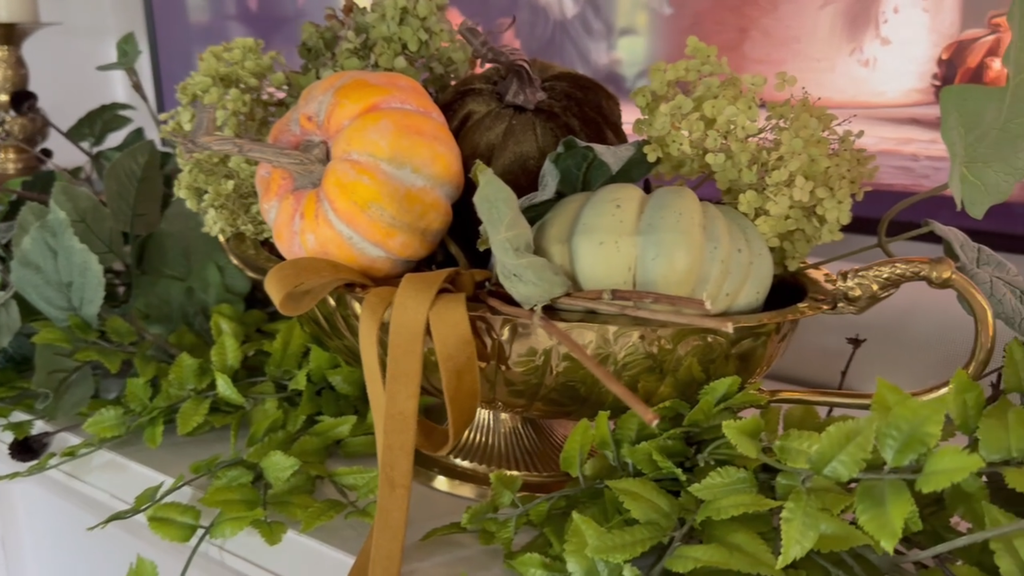 Fall decorating ideas featuring a historic home mantel styled with a vintage brass bowl filled with pumpkins and cozy autumn decor.